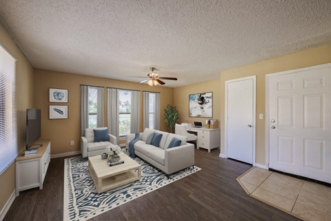 a living room with furniture and a ceiling fan